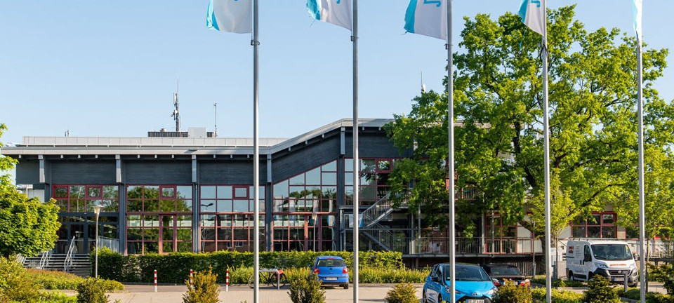 Parking spaces in front of a building with glass façade